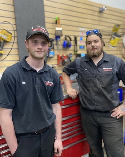 Mechanics, Ben and Chad, stand in front of a toolbox in the auto repair shop