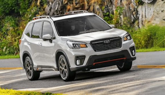 Why does my Subaru rattle? With Collinsville Auto Repair in Canton, CT. Image of 2019 Subaru forester white with black and red trim driving on a mountainside road in Connecticut.