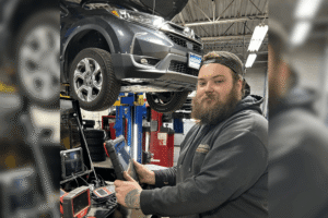 Auto diagnostics, auto repair in Canton, CT, at Collinsville Auto Repair. Image of a technician using advanced diagnostic equipment while inspecting a Honda vehicle on a lift, highlighting accurate troubleshooting, check engine light diagnostics, and professional testing to identify vehicle issues and restore reliable performance.