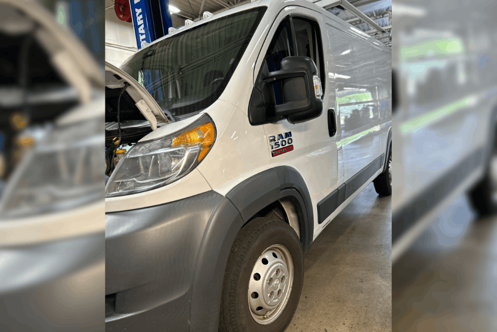 Fleet maintenance, auto repair in Canton, CT at Collinsville Auto Repair. Image of a white Ram ProMaster 1500 van with the hood open inside the service shop for inspection and maintenance.